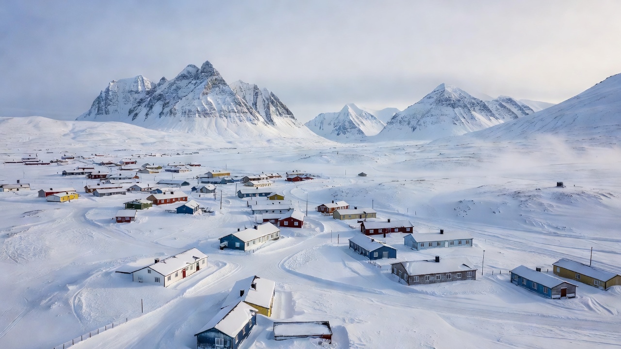 Remote subarctic settlement of Longyearbyen in Svalbard surrounded by snow mountains